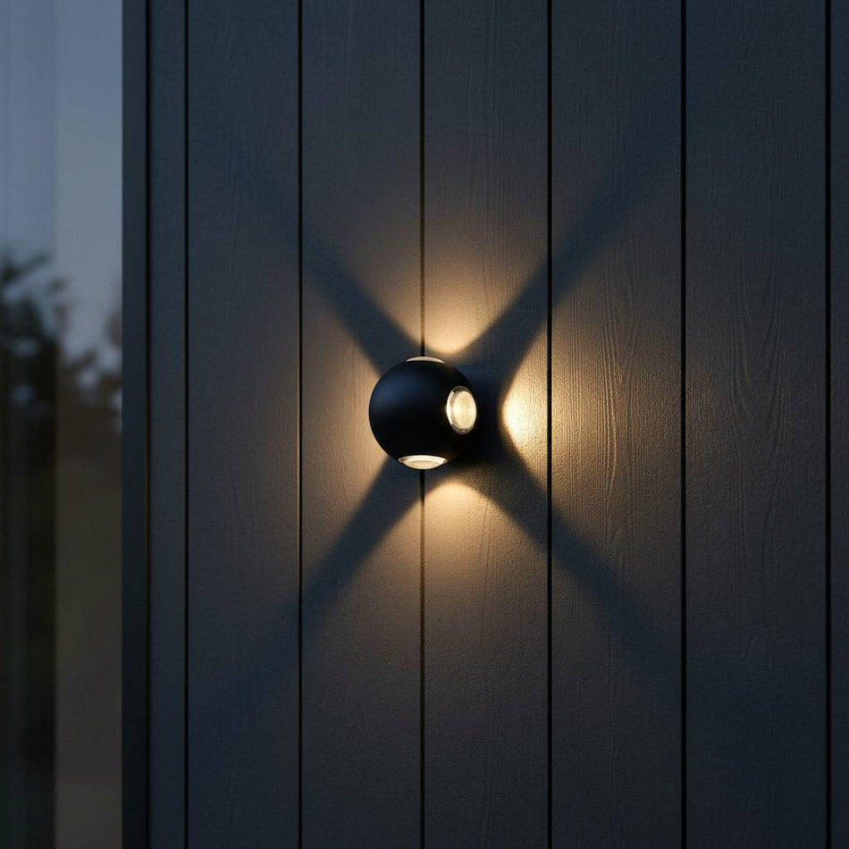 black outside wall light fixture mounted on the wooden exterior wall of a modern house