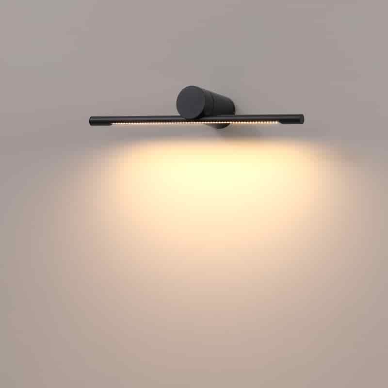 black sign wall light shown mounted on a white wall 