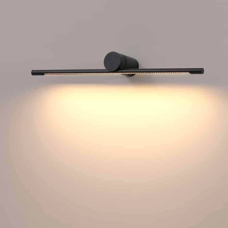 black over sign light shown mounted on a white wall 