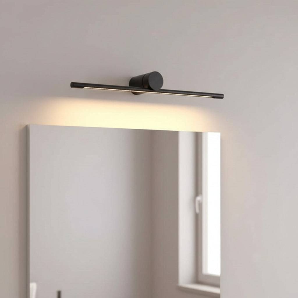 black bathroom light fixture above mirror mounted on the wall in a modern bathroom