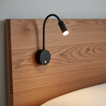 black dimmable reading light for bed mounted on a wooden bed headboard