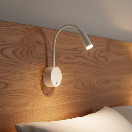 white dimmable bedroom reading light mounted on a wooden bed headboard