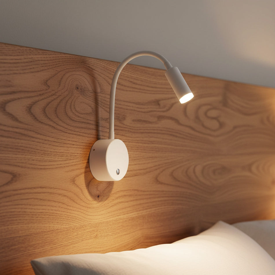 white dimmable bedroom reading light mounted on a wooden bed headboard