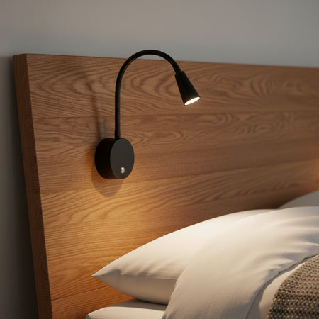 black dimmable bedside reading light installed on a wooden bed headboard