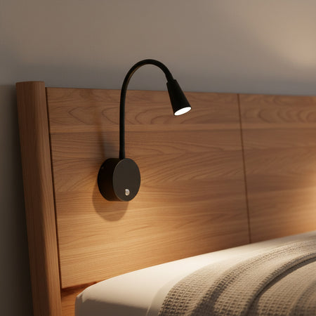 black dimmable bedside reading light installed on a modern bed headboard