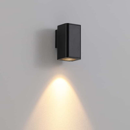 black out door wall downlight mounted on a white wall 