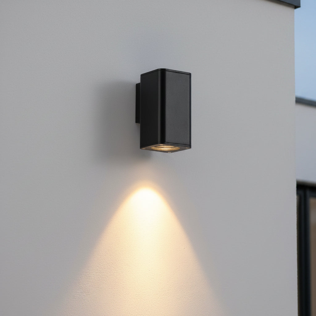 black outdoor wall downlighter mounted on a rey exterior wall 