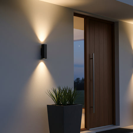 black 12 watt up and down exterior light mounted on the wall of a modern home outside