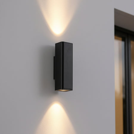 12 watt black up and down exterior light closeup on an outdoor wall