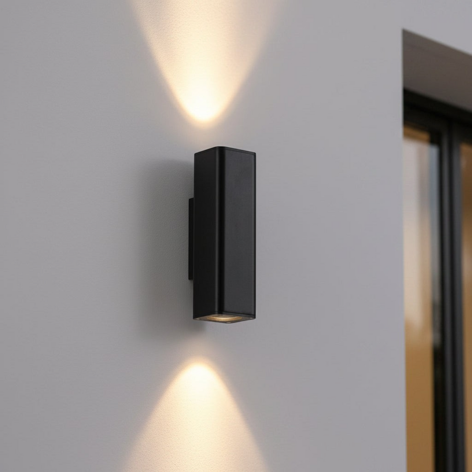 12 watt black up and down exterior light closeup on an outdoor wall