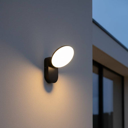 Black outside house wall light mounted on the exterior wall of a modern house