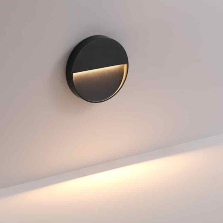 black flush mount wall sconce mounted on a white wall 