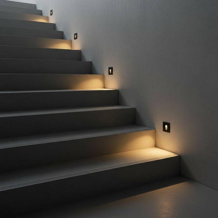 black outdoor step light fixture mounted on the wall alongside outside steps 