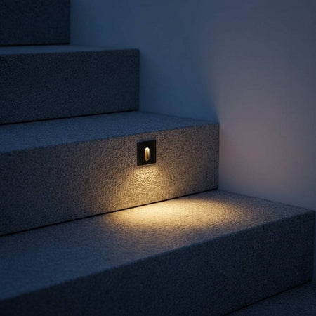 black outdoor step light fixture mounted in a concrete outdoor step riser