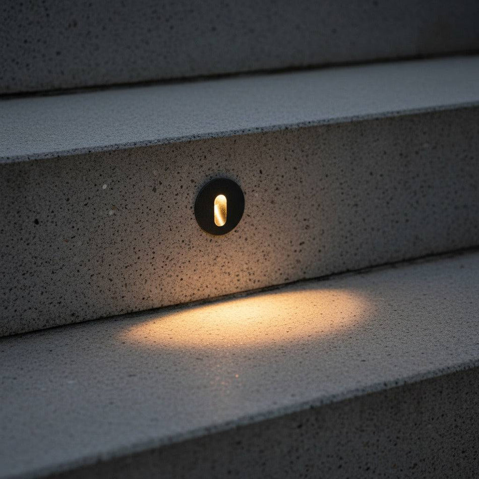 black outdoor stair step light mounted into concrete steps outside 