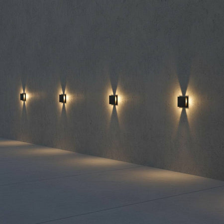 black outdoor step light mounted along an exterior wall in a row