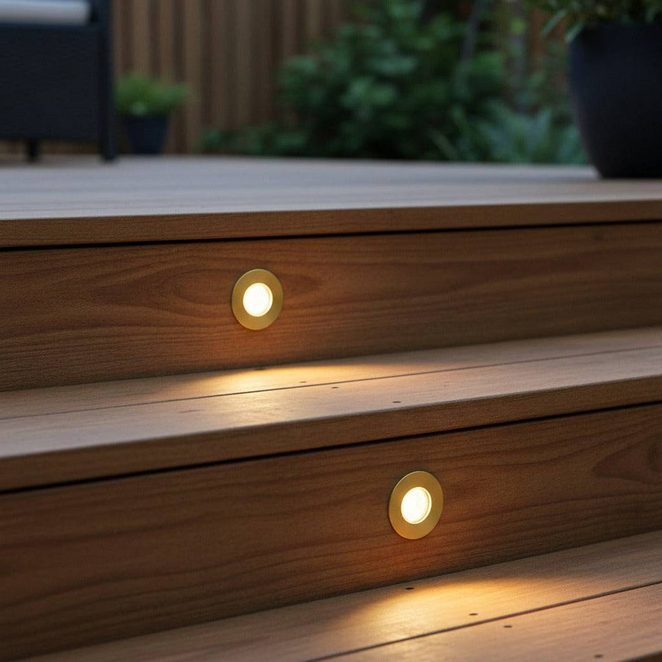 brass in ground deck light recessed into wooden outdoor stair risers