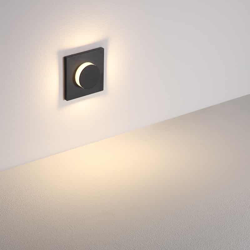 black flush mount sconce light shown mounted on a white wall 