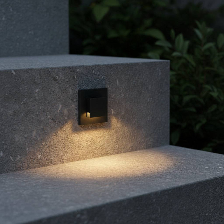 black exterior stair lighting mounted in the risers of concrete outdoor steps 