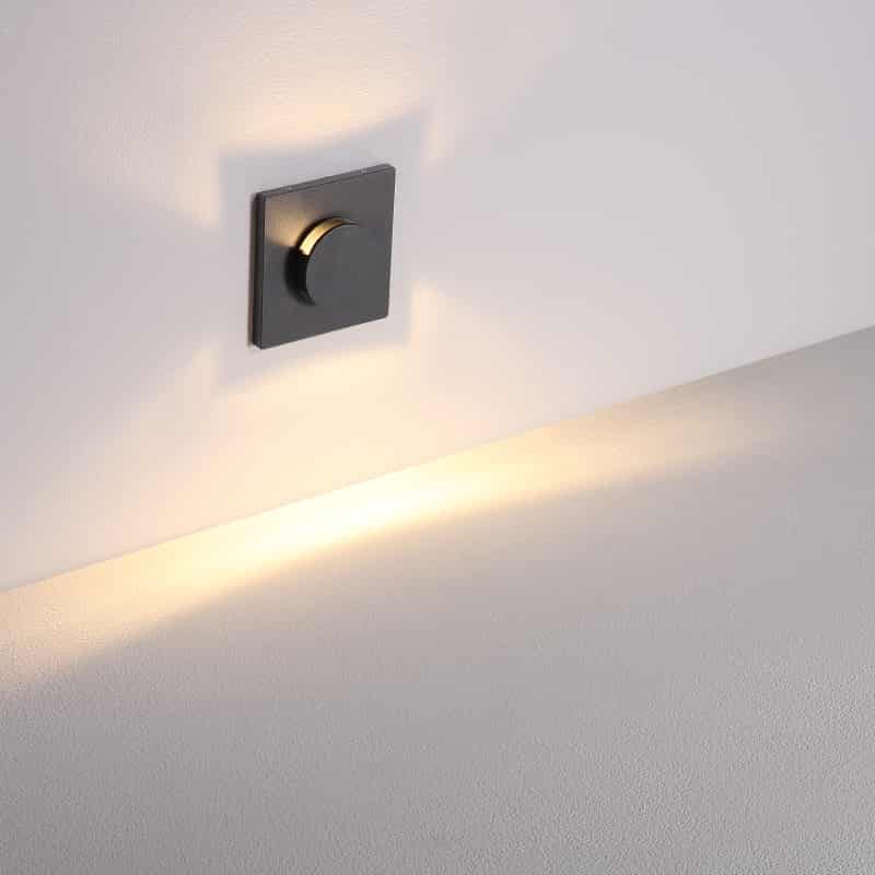 black recessed outdoor wall light shown mounted on a white wall 