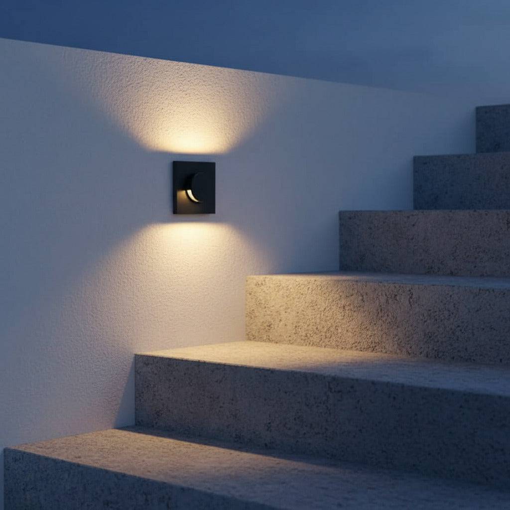 black recessed outdoor wall light mounted alongside some outdoor steps 