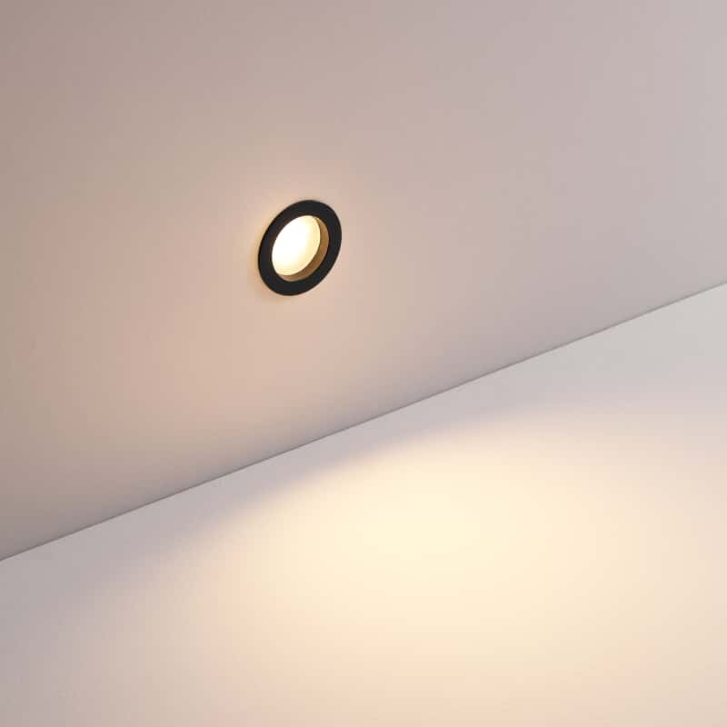 3 watt round black inset garden wall light mounted on a white wall