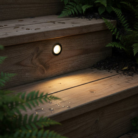 3 watt round black inset garden wall light mounted in wooden steps