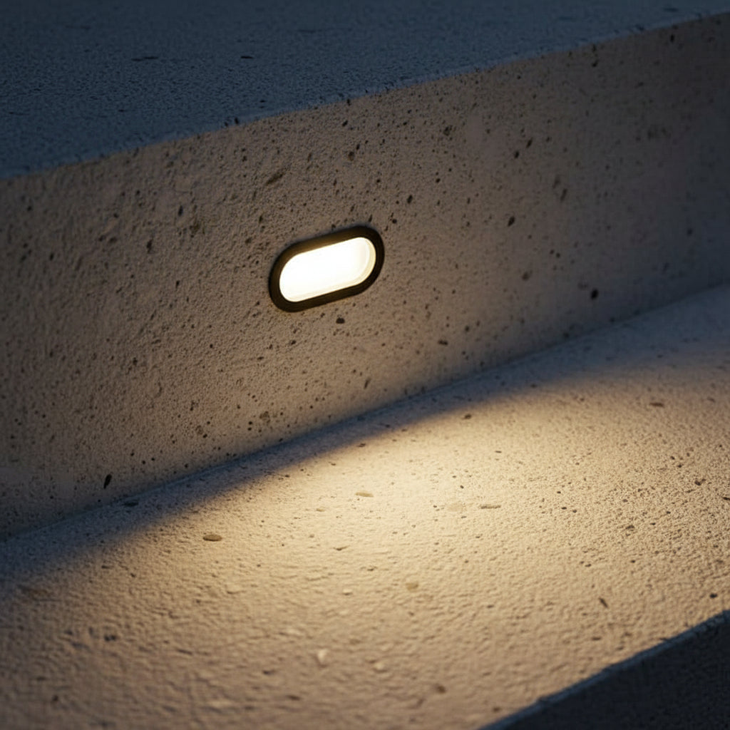 6 watt black oval recessed exterior wall light installed on a concrete step 