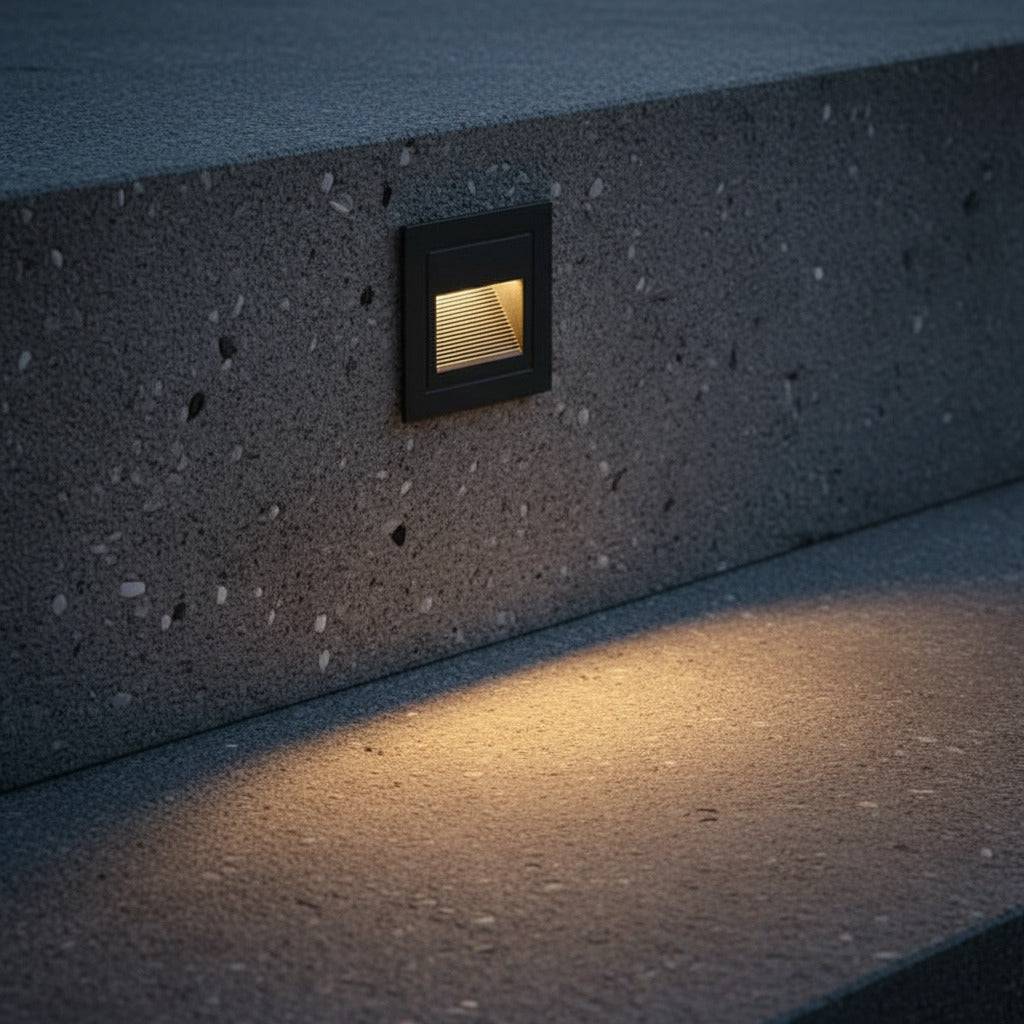 black stair step lighting installed into a concrete exterior step 