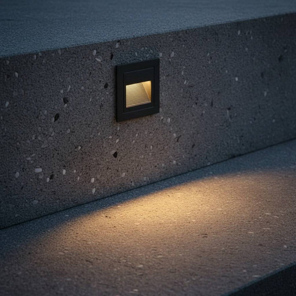 black stair step lighting installed into a concrete exterior step 