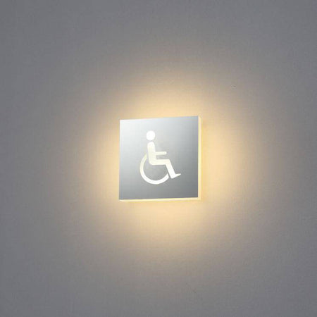 LED disabled toilet sign mounted on a white wall 