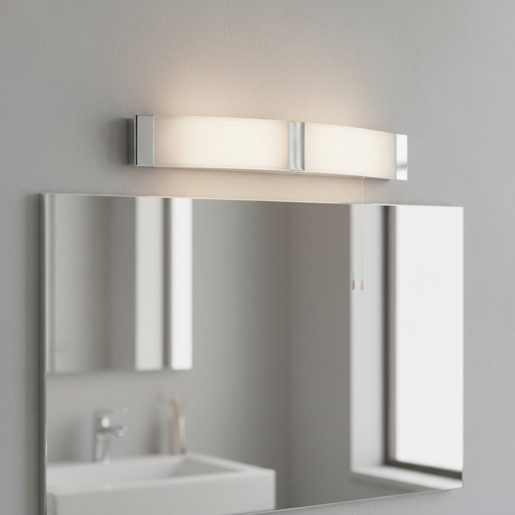 bathroom shaver light mounted above a large mirror in a bathroom 