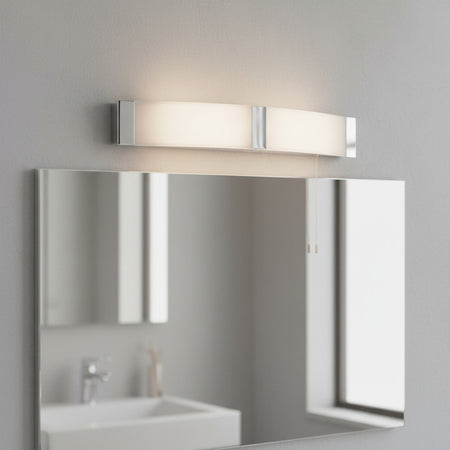 bathroom shaver light mounted above a large mirror in a bathroom 