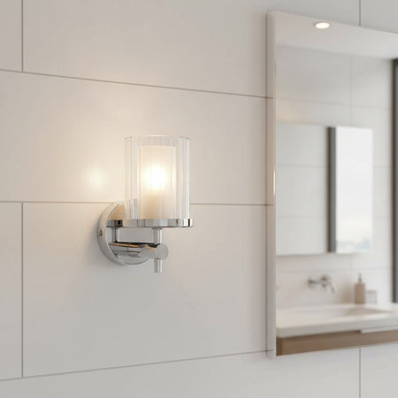 polished chrome bathroom wall light mounted on a tiled bathroom wall 