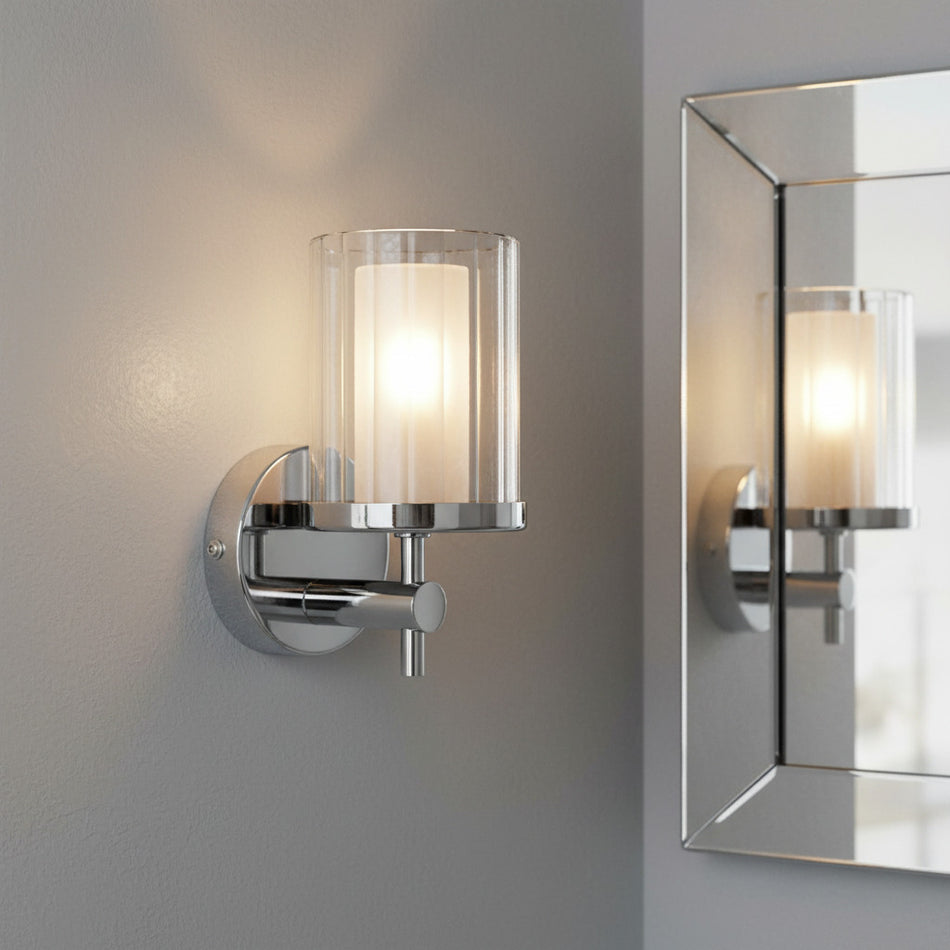polished chrome bathroom wall light mounted on a grey wall in a bathroom