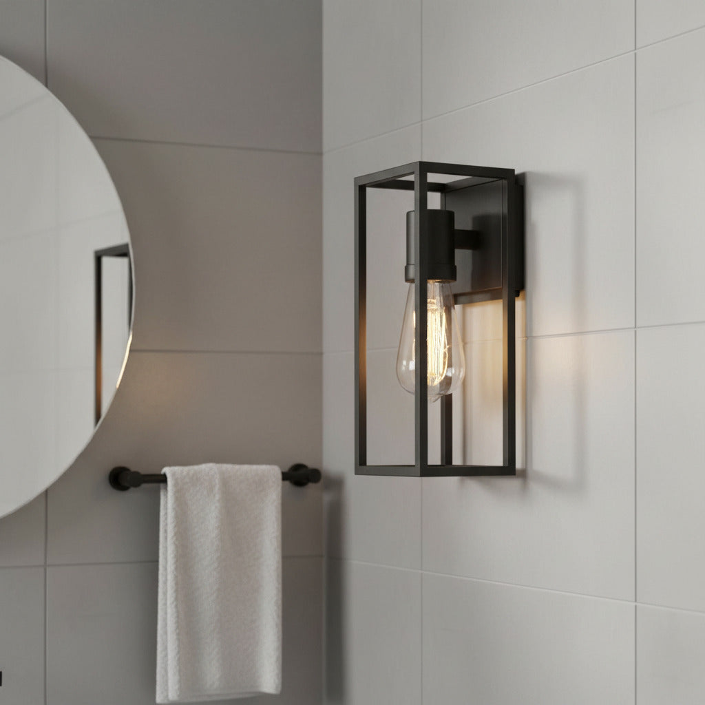 matte black bathroom wall sconce mounted next to a mirror in a bathroom