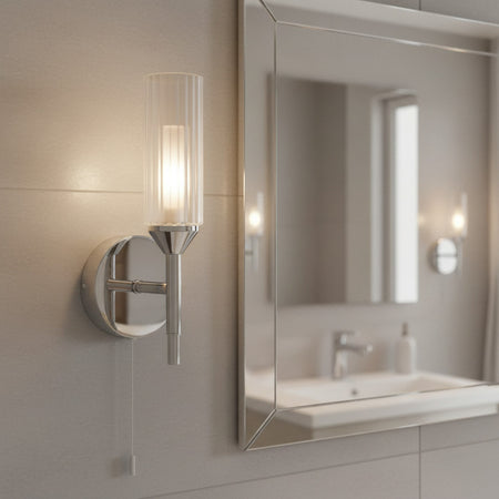 chrome bathroom wall light with pull cord mounted in a modern bathroom