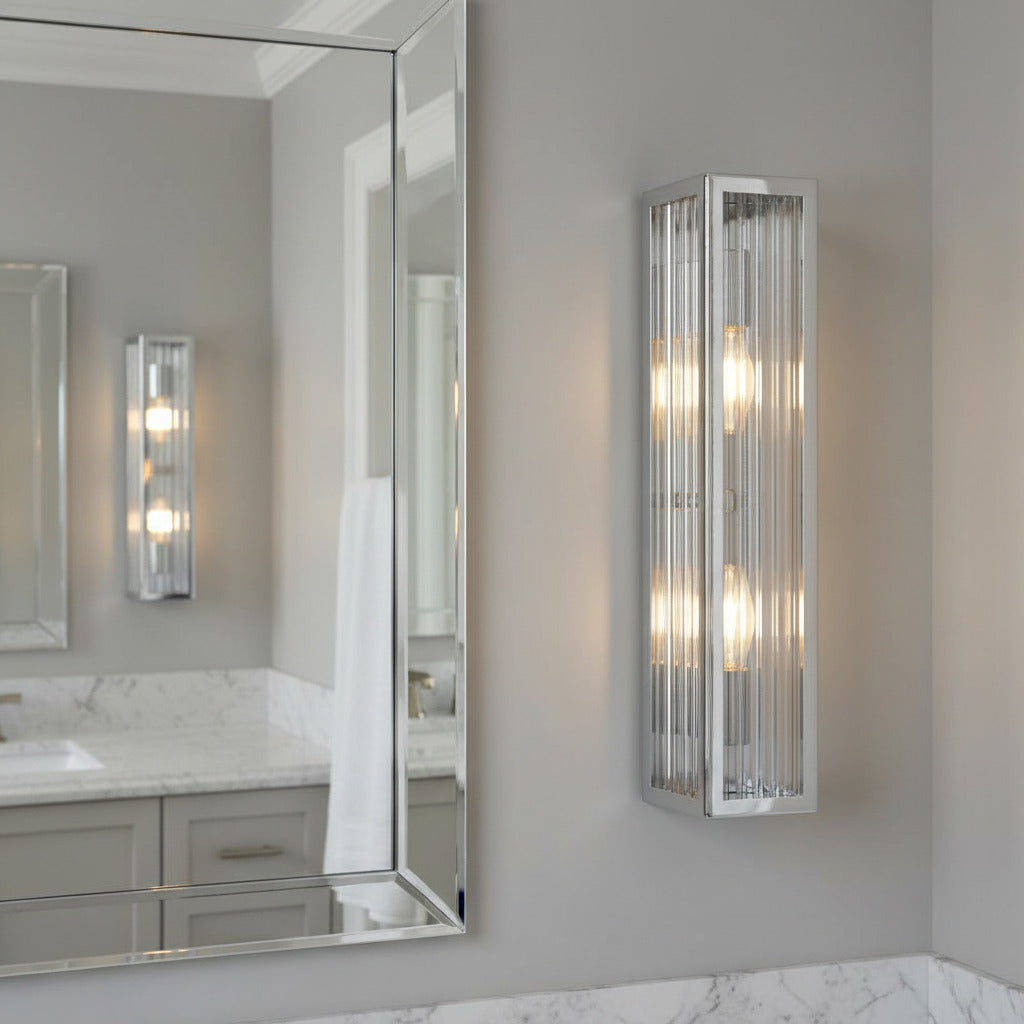 chrome bathroom vanity wall light mounted next to a bathroom mirror