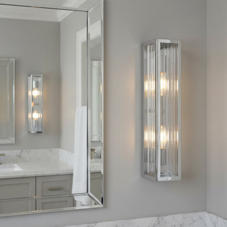 chrome bathroom vanity wall light mounted next to a bathroom mirror