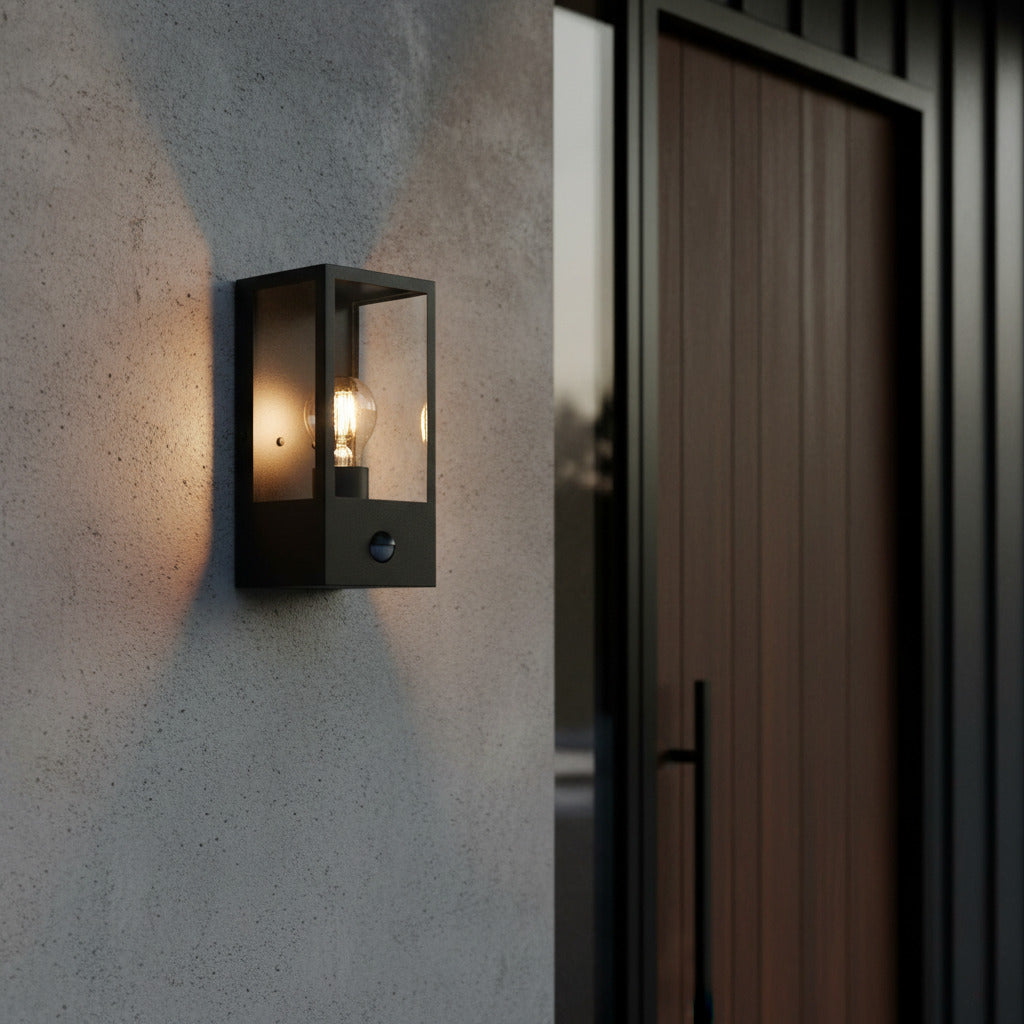 black outside sensor wall light mounted on the wall next to a front house door