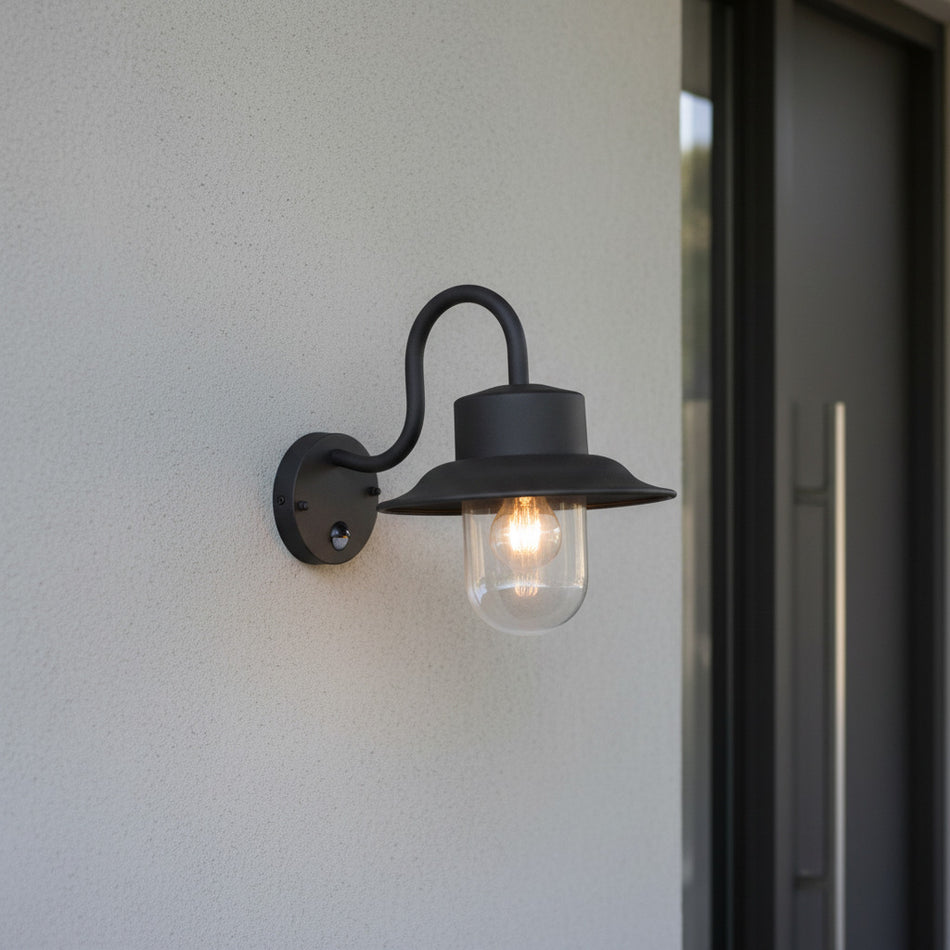 black motion sensor outdoor wall light mounted on the wall outside a modern house