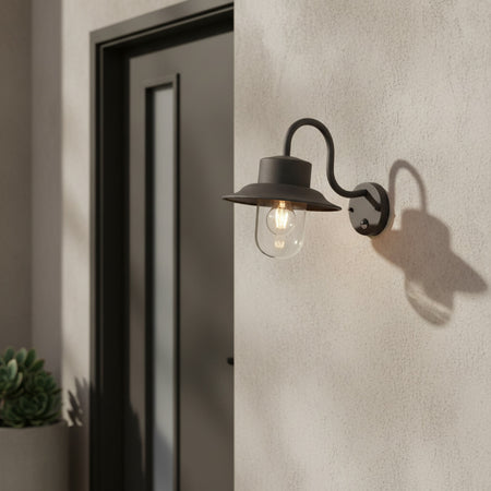 black motion sensor outdoor wall light mounted on the wall outside a modern home