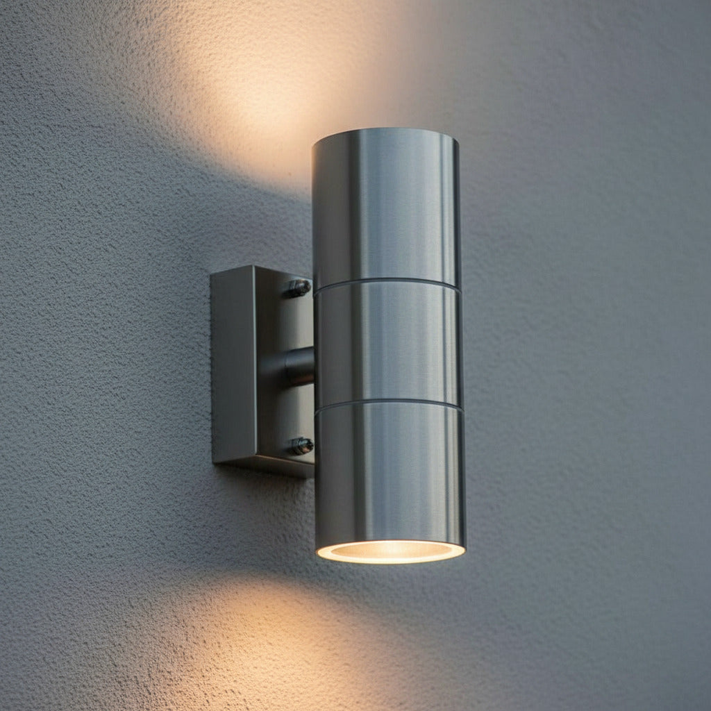 stainless steel external up down light mounted on an exterior textured wall 