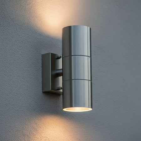 stainless steel external up down light mounted on an exterior textured wall 