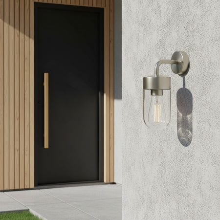 stainless steel exterior lantern wall light mounted outside a modern home