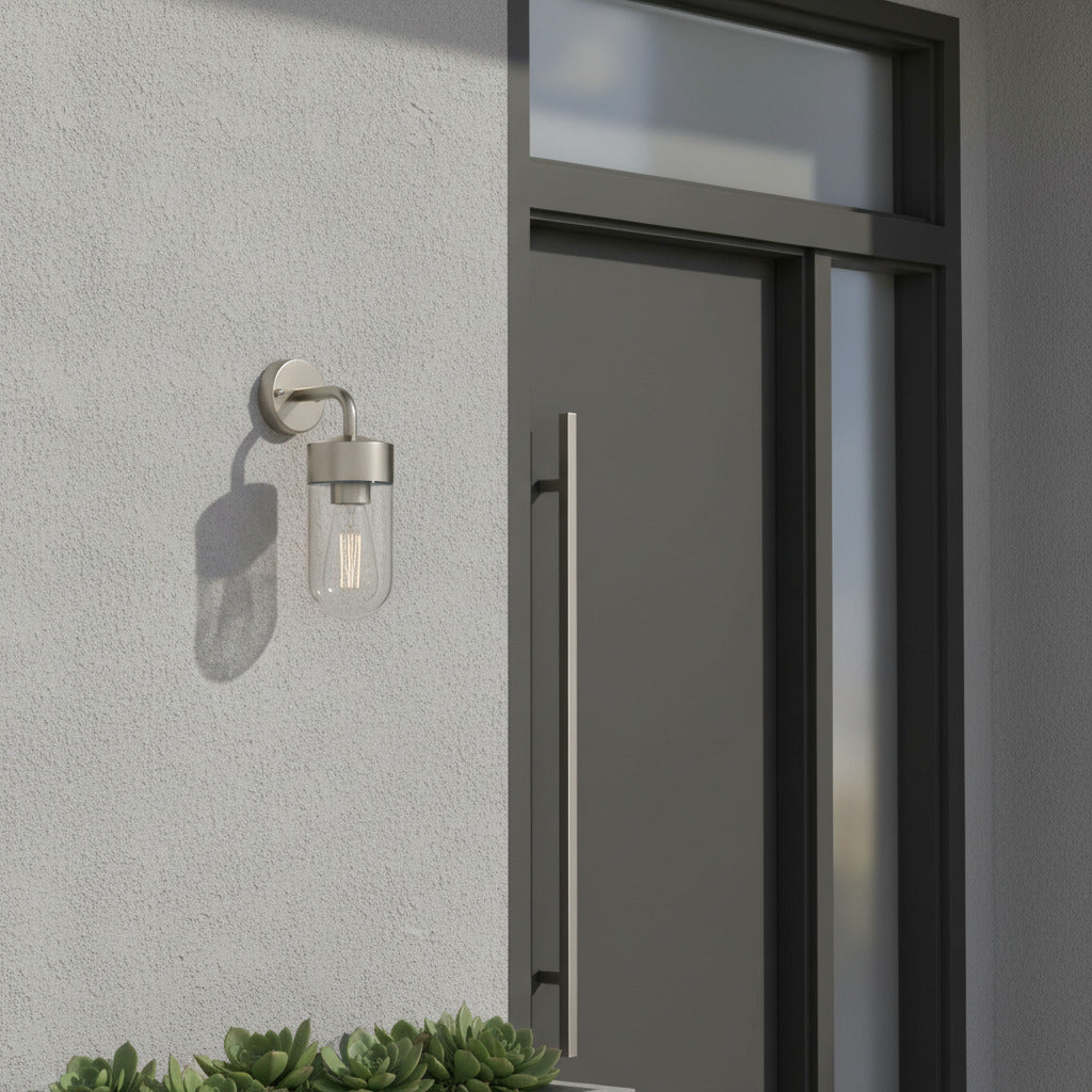 stainless steel exterior lantern wall light installed next to a house front door 
