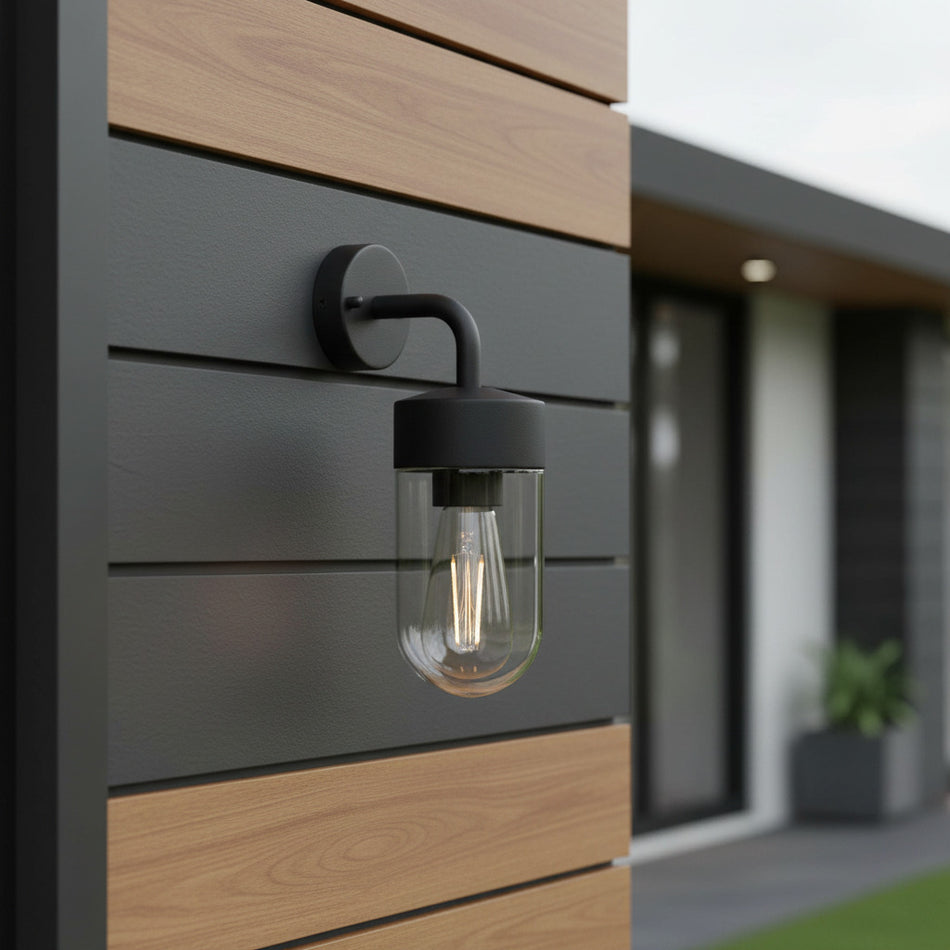 black lantern outside light mounted on a wooden wall outside a home