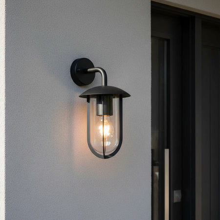 black external lantern wall light mounted next to a home front door 