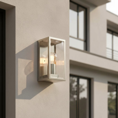stainless steel outdoor wall sconce light mounted on the wall of a modern home 