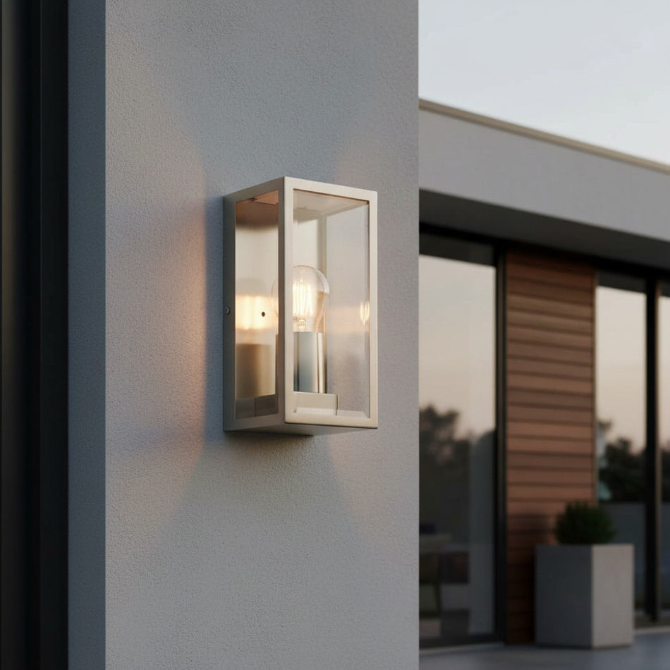 stainless steel outdoor wall scone light mounted on the exterior wall of a house